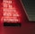 Red neon letters are mounted on a dark tiled wall, displaying the words Poker, Sic Bo, Roulette, Black Jack, and Automaten.