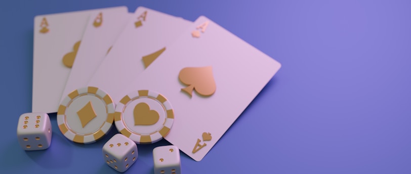 A set of playing cards displaying four aces is laid out on a surface. Alongside them, there are two poker chips with heart and diamond symbols, and three six-sided dice showing different numbers. The background is a smooth gradient of purple, creating a thematic gaming or casino atmosphere.